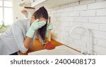 Small photo of Sad woman grapples with a sink cleaning issue, attempting to unclog the basin and clutching a plunger, conveys the frustration and challenges that can arise in managing household drain plumbing.