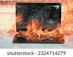 Burning laptop and keyboard, equipment fire due to faulty battery and wiring. Laptop Computer setting the world on fire. Laptop burning in flames. Fire hazard. Losing valuable data. Laptop Damage. 