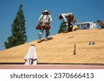 Small photo of Lake Forest, California - USA - October 2, 2023: Roof construction site. Removal of old roof, replacement with new shingles, equipment and repair. Roofs are very important for houses. Roof Repair.