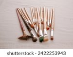 Small photo of Paint Brushes. Various Sizes and Shapes of Paint Brushes. Paint Brush. Art Supplies. Art Project. paint brush. tools. set of dirty brushes in row. artist brushes on a white background.