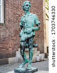 Small photo of Dusseldorf, North Rhine Westphalia, Germany - August 2019: Statue of a molder boy by Willi Hoselmann 1932 in the old town market square