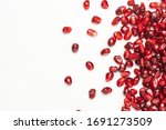 Pomegranate Seeds On A White...