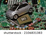 Small photo of Toy car with CPU. The shortage of microchips and semiconductors creates a shortage of new cars. Conceptual image for semiconductor shortage disrupting production of the automotive industry.