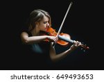 Beautiful violinist girl playing the violin