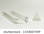 Small photo of u-shaped absorption tube (broken in half) and small transparent funnel without trunk. obsolete laboratory glassware