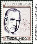 Small photo of ULAANBAATAR, MONGOLIA - MARCH 25, 2014: A stamp printed in Mongolia shows portrait Niels Henrik David Bohr (1885-1962), 2014