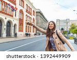 Small photo of Young woman hailing a taxi ride. Beautiful charming woman hailing a taxi cab in the street. Businesswoman trying to hail a cab in the city. Tourist woman hailing a taxi