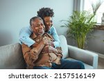 Small photo of Portrait of father and daughter laughing and being happy. Daughter with her arm around her father both smiling. Smiling young woman enjoying talking to happy old father.