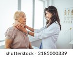 Small photo of Doctor putting neck orthopaedic collar on adult injured woman. Doctor talking to a senior patient with cervical collar at the hospital. Doctor applying cervical collar on neck of woman in clinic