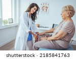 Small photo of Physical Doctor consulting with patient Knee problems Physical therapy concept. The doctor is gently touching the tendons around the knee and the knee cap and trying to determine the cause of pain.