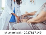 Small photo of Doctor examining patient knee. Physiotherapist exam patient's knee. Senior patient with knee injury visit his physiotherapist. Doctor the traumatologist examines the patient the patient's ankle leg