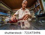 Small photo of LISBON, PORTUGAL - 25 JUNE 2017: man pouring in the glass in the Ginjinha Registada, the oldest and most famous establishment in Lisbon dedicated to sell Ginjinha, a type of Sour Cherry Brandy