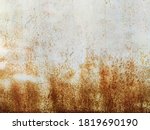 Corroded metal background. Rusted grey painted metal wall. Rusty metal background with streaks of rust. Rust stains. The metal surface rusted spots. Rystycorrosion.