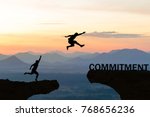 Men jump over silhouette failure commitment to success