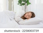 Beautiful Attractive Asian woman sleep and sweet dream lying on bed in cozy bedroom in the morning feeling so relax and comfortable.Healthy Young female sleep with bedtime at home.Healthcare Concept