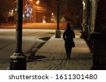 a lonely, frightened girl walks down a snow-covered street at night, in danger of being robbed and freezing