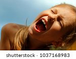 Small photo of Children,People,Emotions Concept.Cropped Shot Of a Screaming Girl.Close up Portrait of A Crying Girl.Head portrait of a furious girl screaming loudly.A young girl shrieking and her eyes are closed.