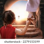 Small photo of Easter and Good Friday concept, Jesus holding child's hand with empty tomb of Jesus Christ at cross on sunset background