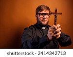 Small photo of Portrait of an exorcist priest with crucifix and black shirt.