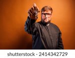 Small photo of Portrait of an exorcist priest with crucifix and black shirt.