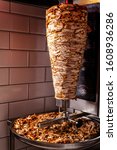 Small photo of Traditional turkish, oriental cuisine. Chicken meat for doner kebab Istanbul. chopped meat lies on a baking sheet. made of meat cooked on a vertical rotisserie.