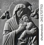 Small photo of A cast-iron bas-relief of the Mother of God's unceasing help. Scene of Blessed Saint Mary holding the child Jesus.
