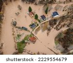 Small photo of Flooded village, fields, farms and houses, aerial drone view. Aftermath of devastating river flood and landslide. Catastrophic floods. Overflowing river, view from above.