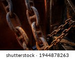 Rusty Iron anchor ship chains caked with dust at old coast ship. Rustic iron chains background.