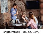 Small photo of Young couple justify themselves in front of angry waitress at a cafe