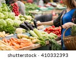 Young Woman Buying Vegetable On ...