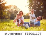 Family with children blow soap bubbles outdoor