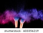 Cosmetics brush and explosion colorful makeup powder background