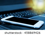 Smartphone screen with blur laptop for background  , copyspace , flare light