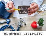 Small photo of Ultrasound examination in cardiology concept photo. Doctor during consultation held in his hand and show to patient printout picture of ultrasound examination with heart pathology of pericarditis