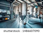 Small photo of Fermentation mash vats or boiler tanks in a brewery factory. Brewery plant interior.