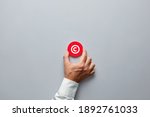Businessman hand holding a red badge with copyright symbol. Property rights and brand patent protection in business concept.
