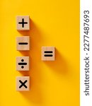 Small photo of Basic mathematical operations symbols. Plus, minus, multiply, divide and equal symbols on wooden cubes. Mathematic or math education and basic calculations for business concept.