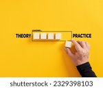 Small photo of Transition of theory into practice. Implementation of theories in practice. Hand places a wooden cube to the loading bar with the words theory and practice.