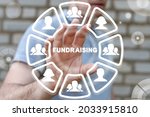 Small photo of Concept of fundraising. Fundraiser using virtual touchscreen clicks a fundraising word.