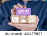 Small photo of Man holding colorful blocks sees inscription: COMPANY REGISTRATION. Concept of new company online registration. Business start up. Brand and identity building process. Company formation procedure.