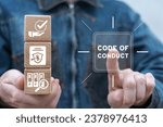 Small photo of Man holding wooden blocks with icons presses virtual button with inscription: CODE OF CONDUCT. Code of conduct business concept. Ethics and respect in working collective. Ethical policy or rules.