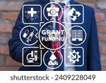 Small photo of Doctor using virtual touch screen sees inscription: GRANT FUNDING. Concept of healthcare grants funding. Medical Innovation Education Grant Fund Application Donation.