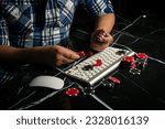 Small photo of Male hands with poker chips near the keyboard. online casino. Online gambling. Poker online.