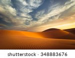 Global warming concept. Lonely sand dunes under dramatic evening sunset sky at drought  desert landscape