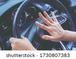 person pushing horn while driving sitting of a steering wheel press car, honking sound to warn other people in traffic concept.
