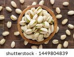 pistachio in shell nuts in bowl on wooden table background.