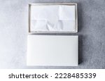 Two white square gift boxes...
