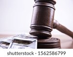 Small photo of Judge's gavel, bills of american dollars as concept business, finance corruption, cash deposit.