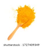 Small photo of Top view isolated wooden spoon with scattered turmeric or curcuma powder.