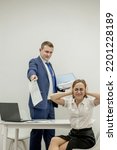 Small photo of Angry boss yelling at his young employee, she is stressed and feeling frustrated: hostile boss and mobbing concept.